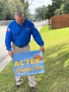 Putting up a yard sign for AC TEX, A/C and Heating in Weatherford TX