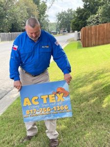 AC Tex Putting in yard sign at customers